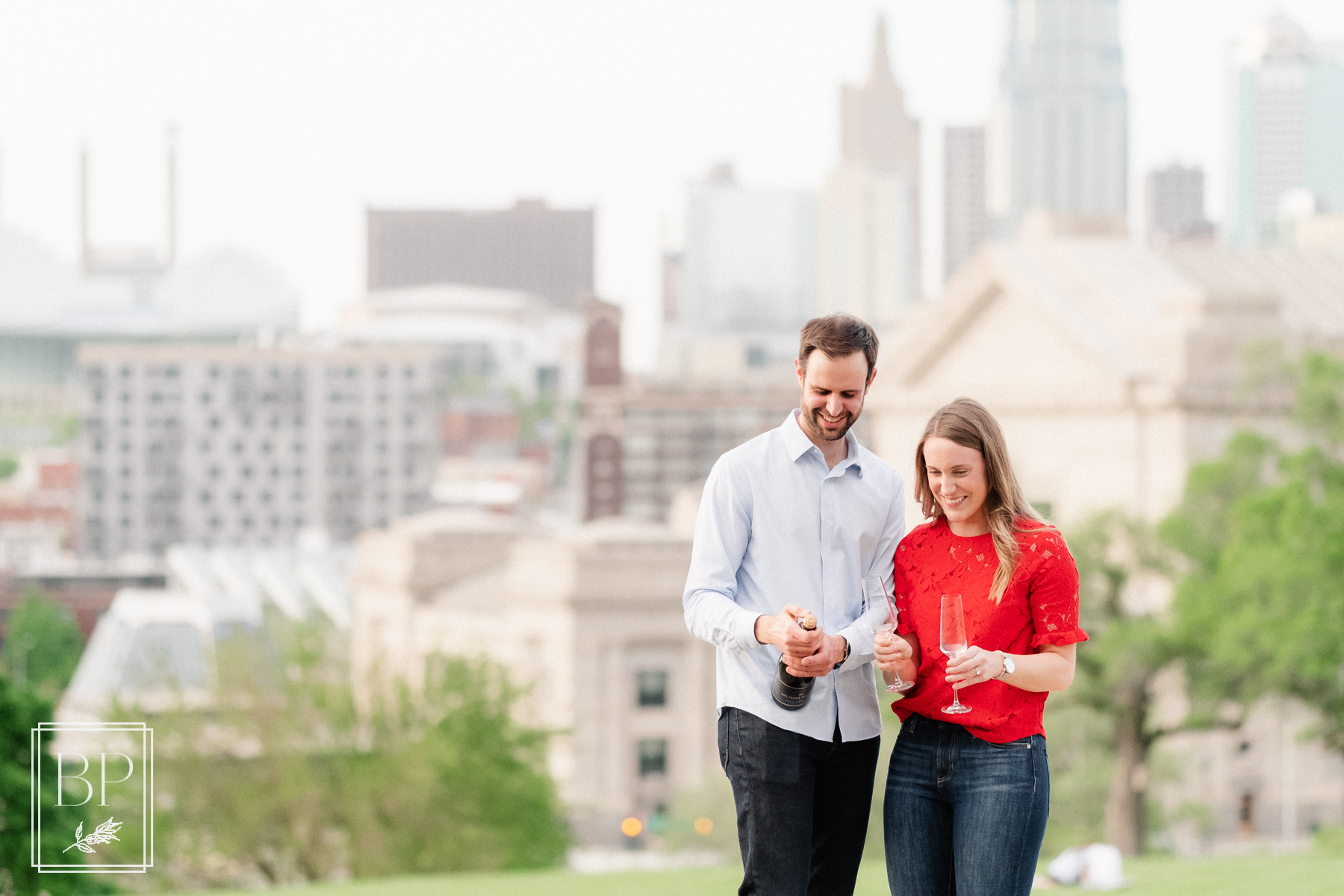 couple's springtime evening surprise proposal champagne toast at Union Station in Kansas City, MO